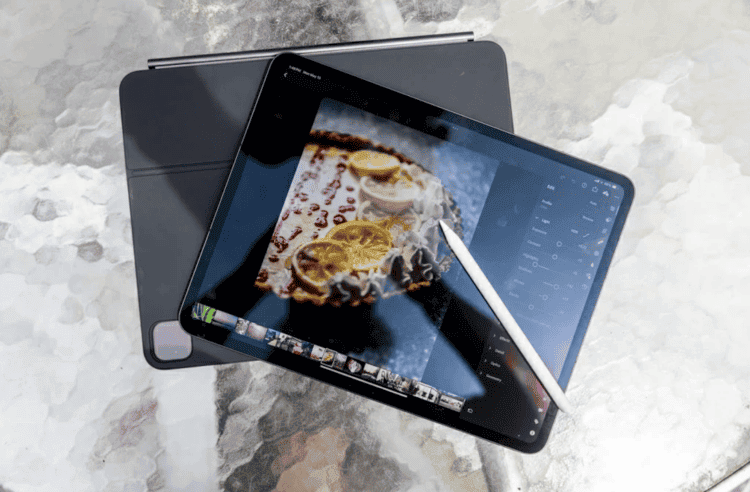 Tablet with stylus and food photo